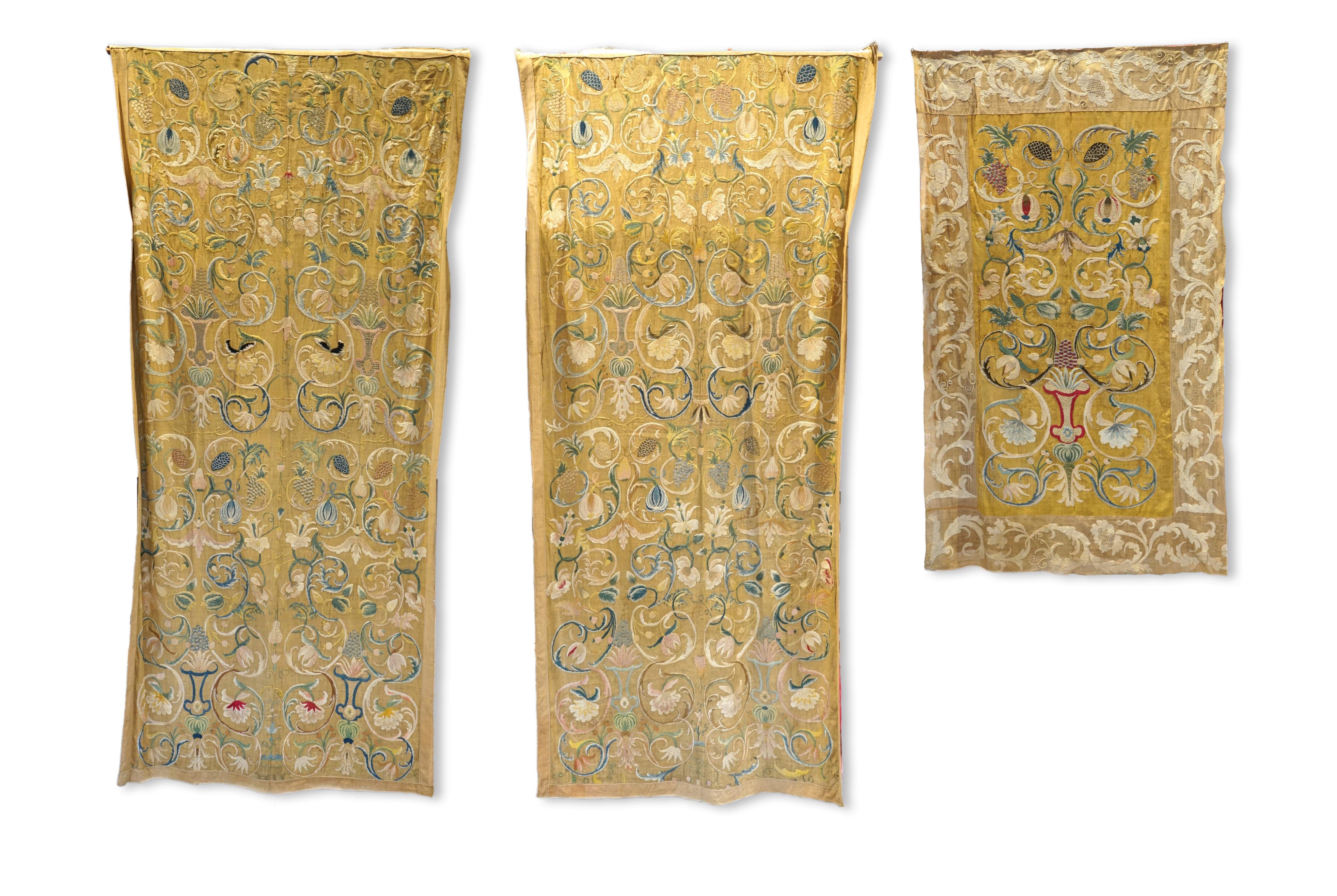 A large pair and one smaller panel of late 18th century Italian silk floss hand embroidered panels, possibly from Florence or Venice, both known for floss embroidery. Thought to be originally sacristy hangings. Elaborate